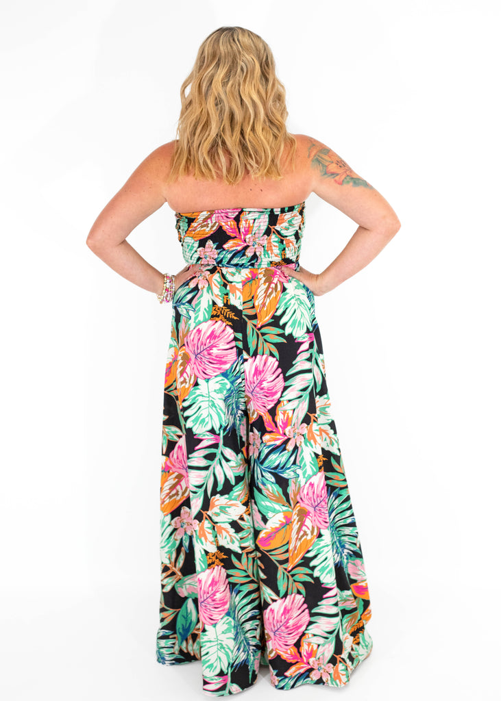 black strapless jumpsuit with colorful tropical print