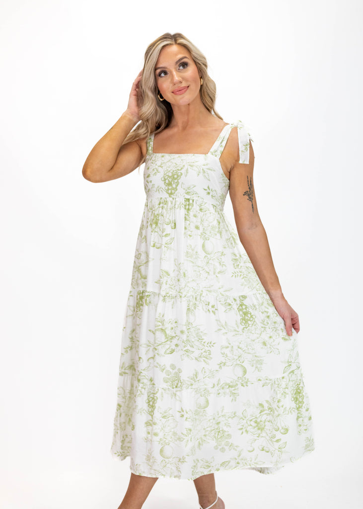 white midi dress with olive green floral print and tie straps