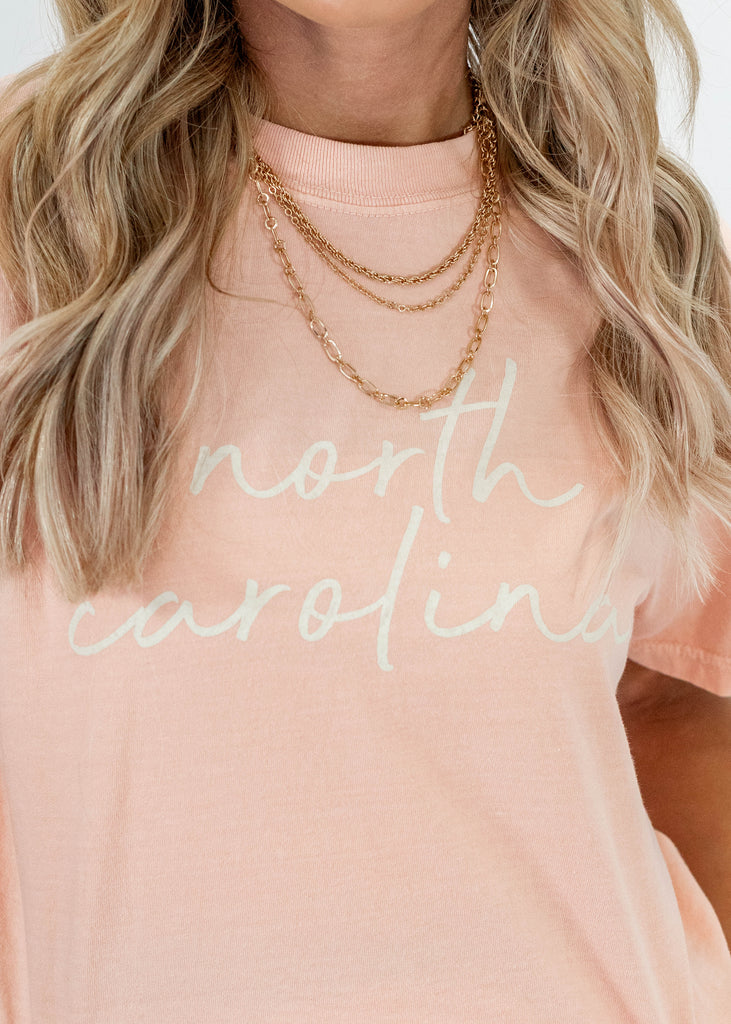 light pink t-shirt with "north carolina" lettering